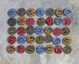 A grid of 36 hand-sculpted shields, each featuring intricate designs inspired by Celtic mythology. The shields display a variety of colorful motifs, including scowling faces, gurning expressions, and detailed knotwork, rendered in vibrant hues of red, blue, green, yellow, and black. The background is a neutral gray, allowing the vivid colors and intricate details of the shields to stand out prominently.