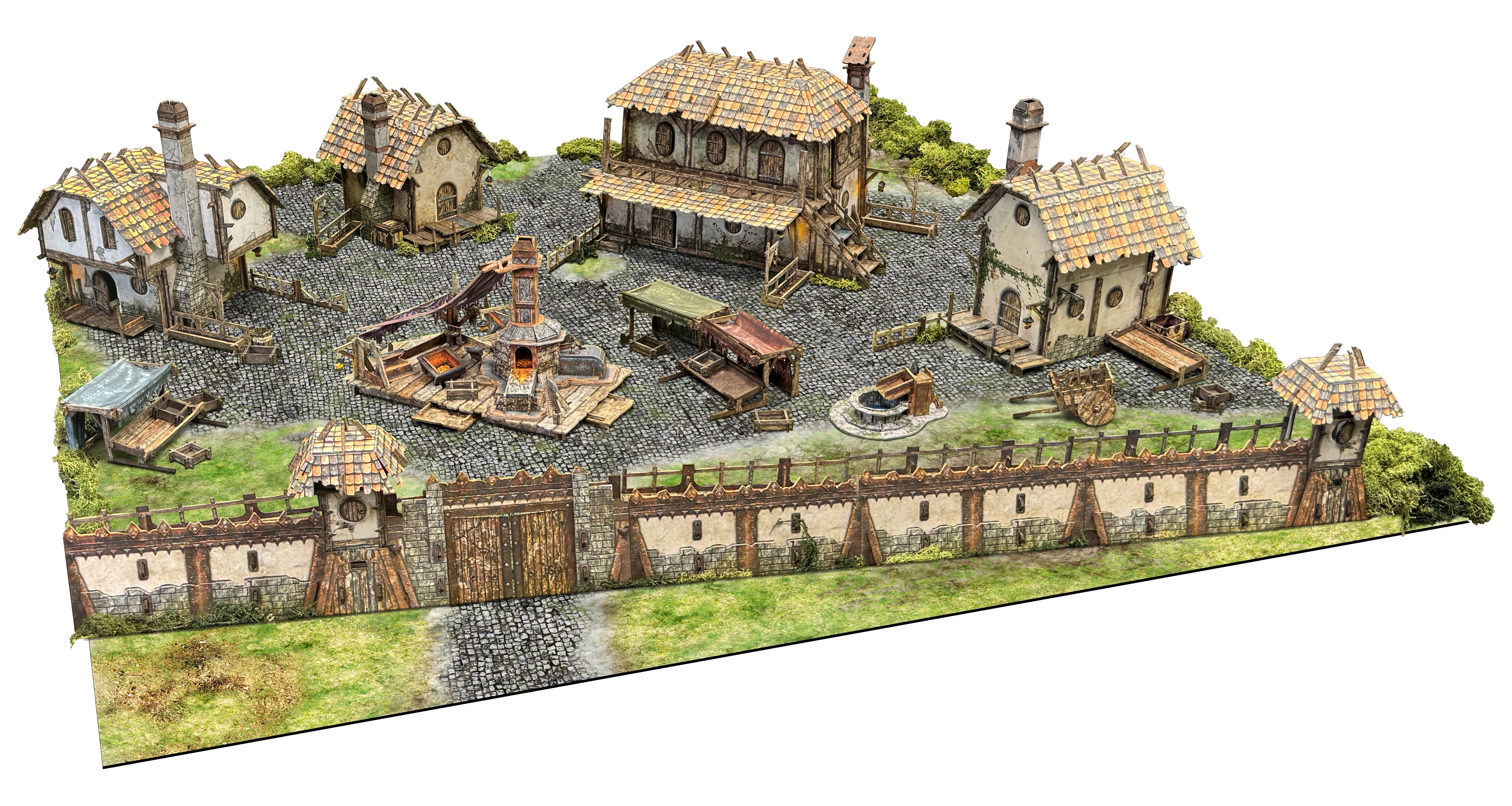 A detailed tabletop terrain scene depicting the Ingonsburn Township, featuring a cobblestone market square surrounded by various buildings, including a large inn, a foundry, and cottages, all enclosed by a secure boundary wall. The buildings have textured roofs and are adorned with furniture, while a central well or forge adds to the bustling atmosphere. Lush green grass peeks through the cobblestones, enhancing the vibrant fantasy setting.