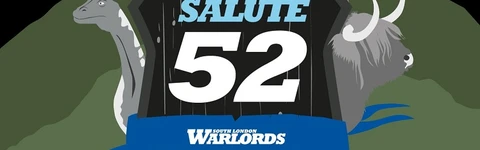 A stylized graphic for Salute 52 features a central shield with the text "SALUTE 52" prominently displayed, flanked by the words "SOUTH LONDON WARLORDS" and the year "2025." Surrounding the shield are four characters: a warrior with a sword and shield, a bagpiper, a soldier in a red coat, and a woman with red hair and a blue mask. In the background, there are elements like a dinosaur and a Highland cow, set against a dramatic sky with lightning. The bottom of the image includes the phrase, "There can be only one day of SALUTE!"