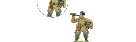 A 28mm miniature of an American paratrooper named "Thirsty Work" is depicted, holding a bottle of wine in one hand while the other arm is posed to hold a pistol. The soldier is dressed in a light green uniform with a backpack and a belt, standing on a grassy base. An inset shows a close-up of the arm holding the pistol, emphasizing the dual options for the model.