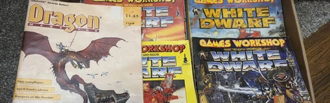 A selection of eary 90s white dwarf and dragon magazines showing the classic stylings