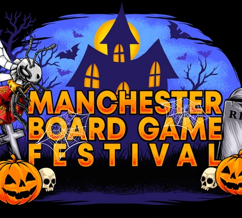 A vibrant graphic features the text "MANCHESTER BOARD GAME FESTIVAL" prominently displayed in bold, orange letters against a dark, spooky backdrop. The scene includes a haunted house with glowing windows, bats flying in the night sky, and various Halloween-themed elements like pumpkins, skulls, and spider webs. The overall atmosphere is festive and eerie, perfectly capturing the Halloween spirit of the event.