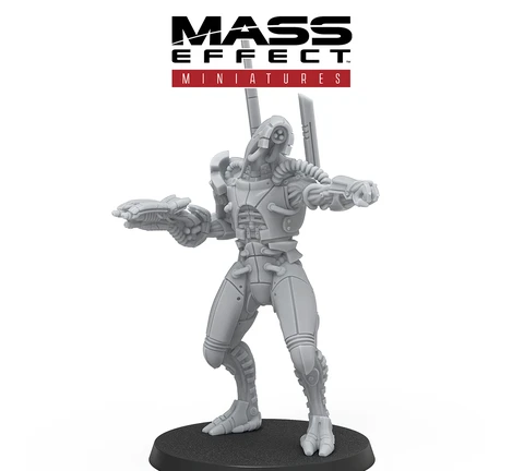 A detailed gray resin miniature from the Mass Effect universe stands on a circular black base, depicting a humanoid figure with a sleek, armored design. The figure features intricate mechanical details, including visible joints and a raised arm holding a weapon, suggesting a combat-ready stance. The Mass Effect logo is prominently displayed at the top, along with the Modiphius Entertainment branding at the bottom.