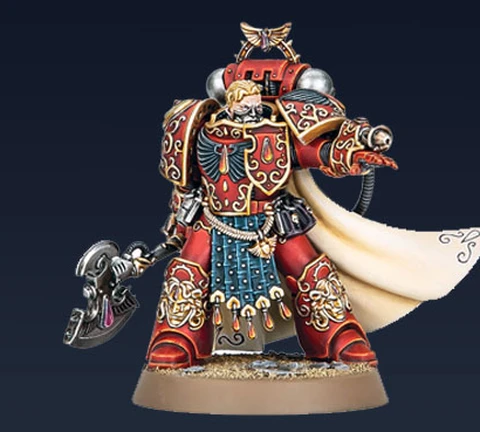 Aster Crohne, a new miniature from Games Workshop, is depicted as a Blood Angels veteran. He wears ornate red armor adorned with gold details and intricate patterns, complemented by a flowing white cape. In one hand, he wields a large, menacing weapon, while his other hand is outstretched, suggesting a commanding presence. The base features a sandy texture, enhancing the overall dynamic of the figure against a dark background.