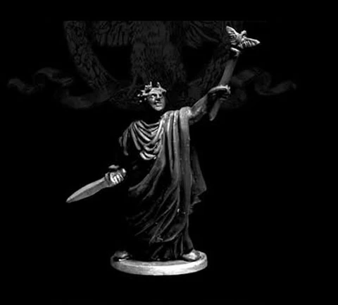 A 28mm scale miniature of Caesar Imperator stands prominently against a dark background. The figure is cast in white metal, showcasing intricate details such as a laurel crown and flowing robes. In one hand, he holds a sword, while the other is raised, delicately supporting a butterfly, symbolizing peace or transformation. The base is circular, providing stability to the figure, which is sculpted with a sense of grandeur and historical significance.