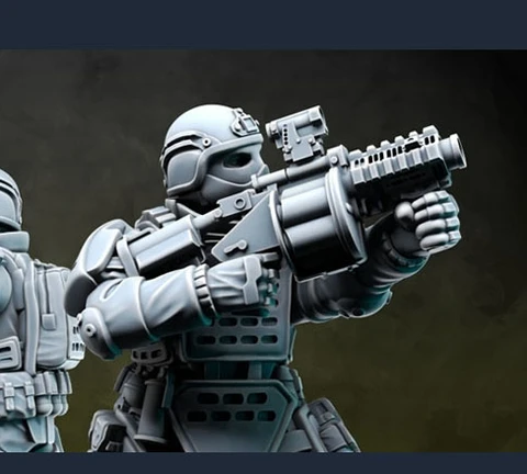 Two detailed miniatures from Anvil Industry's Special Forces range are positioned back-to-back, each holding futuristic firearms. The figures are clad in tactical armor with various pouches and equipment, showcasing a blend of sleek design and functionality. The miniatures are presented in a gray, unpainted finish, highlighting their intricate details and dynamic poses.