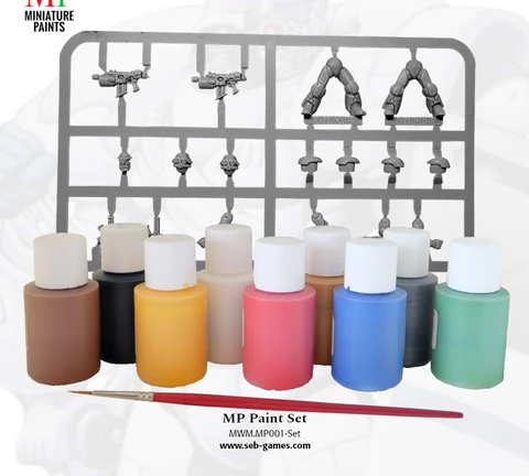 A collection of nine bottles of water-based acrylic paints in various colors, including black, white, dark green, mid blue, bright red, golden yellow, leather brown, bright gold, and chain mail, is displayed in the foreground. Behind the paint bottles is a sprue containing two Viridian Interdicts Marines, showcasing various miniature parts. A high-quality synthetic brush is positioned in front of the paint bottles, emphasizing the set's painting essentials.