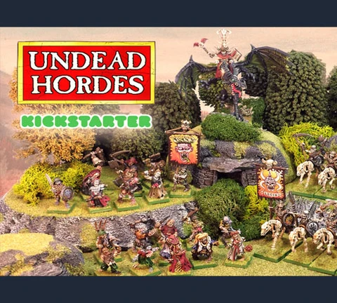 The scene features a vibrant tabletop display showcasing the "Undead Hordes" miniatures from Red Bard Games' Kickstarter campaign. In the foreground, a variety of skeletons and zombies are arranged on grassy terrain, with some holding banners and others in dynamic poses. A prominent liche king rides a zombie dragon atop a rocky outcrop, while additional figures, including a necromancer and various undead warriors, populate the scene, surrounded by lush greenery and stone formations. The overall composition exudes a classic fantasy aesthetic, emphasizing the theme of an undead army ready for battle.