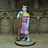 A blue-skinned humanoid figure stands confidently, adorned in a flowing purple robe with a golden belt and a yellow shoulder cape. The character holds a large, ornate staff with a textured grip, and wears a crown-like headpiece featuring butterfly motifs. The backdrop consists of stone walls with gothic arches, enhancing the fantasy setting.