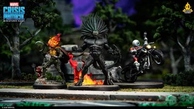 Two miniature figures on bases: one with a skeletal, armored design, glowing red flames on head and chest, holding a hammer, standing on a rocky surface; another with a muscular, black-skinned figure with a spiked helmet, flexing arms, surrounded by fire.