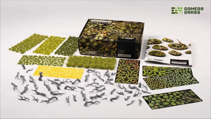 Jungle Floor Basing Box with grass tufts, leaves, and scattered gray twigs.