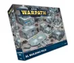 A box for the "Epic Warpath XL Building Pack" features a detailed illustration of various modular sci-fi buildings, showcasing a mix of structures including command centers and fortified outposts. The buildings are predominantly gray with metallic accents, set against a sandy terrain. The box prominently displays the title "EPIC WARPATH" at the top, with the label "XL BUILDING PACK" clearly visible at the bottom.