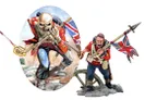 A detailed miniature of a British soldier from the Crimean War stands prominently on the right, holding a spear and a Union Jack flag, with an intense expression. To the left, an illustration features a skeletal figure in a red uniform, also holding a spear and displaying a similar flag, set against a backdrop of a battlefield. The soldier is positioned on a rocky base, while the illustration is framed in an oval shape.