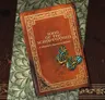 Brown book titled "Song of the Scriptorium: A Librarian's Apprentice Mystery" with a blue butterfly on it.