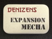 A small, silver tin features the text "DENIZENS" in bold red letters at the top and "EXPANSION MECHA" in large, black, stencil-style font below. The tin's surface has a smooth, metallic finish, and it is set against a dark background, emphasizing its compact and portable design. This packaging represents the new expansion for the Space Denizens wargame, which includes mechs and terrain features.