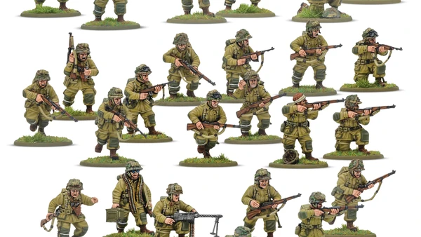 A collection of multi-part plastic miniatures representing US Airborne soldiers in early war, reinforced M42 jump uniforms. The figures are posed in various action stances, showcasing a range of weapons including rifles, submachine guns, and a bazooka, along with additional gear like magazine pouches and a signal lamp. The miniatures are set on grassy bases, highlighting their detailed sculpting and variety within the thirty-man platoon.