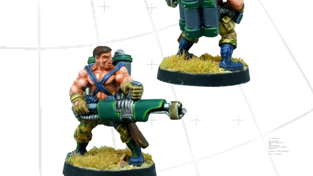 A detailed miniature figure of a commando equipped with a flamethrower, showcasing muscular features and wearing a blue and green outfit. The figure stands on a round base with tufts of grass, and a large backpack containing gas canisters is visible on its back. The image presents the figure from both the front and back, highlighting the flamethrower and the character's rugged design.