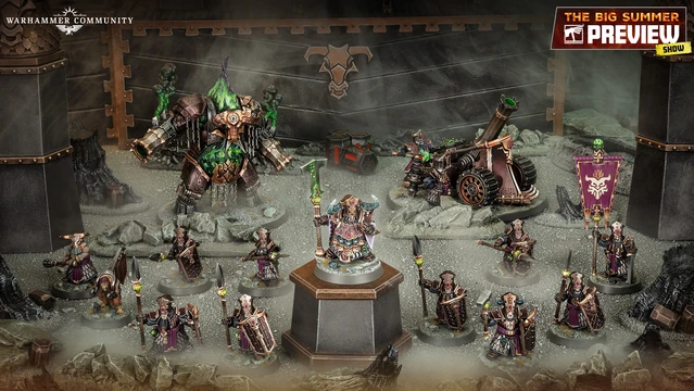 A detailed display of the new Zharrdron army features various miniatures set against a dark, industrial backdrop. In the center, a prominent War Despot stands on a pedestal, clad in imposing armor and wielding a staff, surrounded by Infernal Cohorts holding spears. To the left, a large, menacing Dominator Engine looms, while a mortar-like Tormentor Bombard is positioned on the right, showcasing the army's dark and chaotic aesthetic.