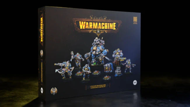 The image features the Cygnar Gravediggers Command Starter box set from the Warmachine tabletop game. The box is prominently displayed, showcasing its dark design with the "WARMACHINE" logo at the top. In front of the box, several miniatures are arranged, including a central warcaster in ornate armor, a heavy warjack, and a three-model unit, all intricately detailed and painted in a blue and gold color scheme. The background is dark, emphasizing the vibrant colors of the miniatures and the box art.