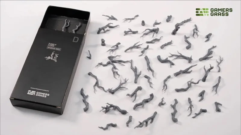 Gray twisted branches scattered on white surface, black box with "D" and logo.