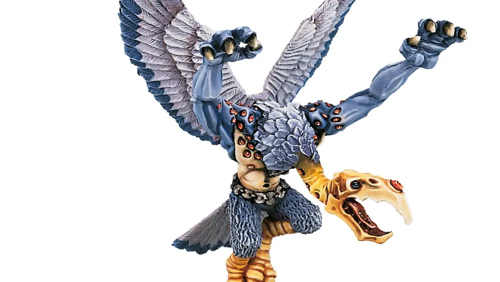 Miniature of a Greater Daemon of Tzeentch with blue-grey skin, golden wings, and ornate armor. Standing on a round base, holding a staff in one hand and a skull-like head in the other. Text in top right corner reads "Warhammer Community."