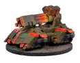 A detailed model of a futuristic tank features a large, prominent missile launcher on top, with vibrant red and orange accents. The tank's body is primarily a dark green, showcasing intricate paneling and mechanical details, while smaller cannons are mounted on the sides. It rests on a textured black base, suggesting a battlefield environment.