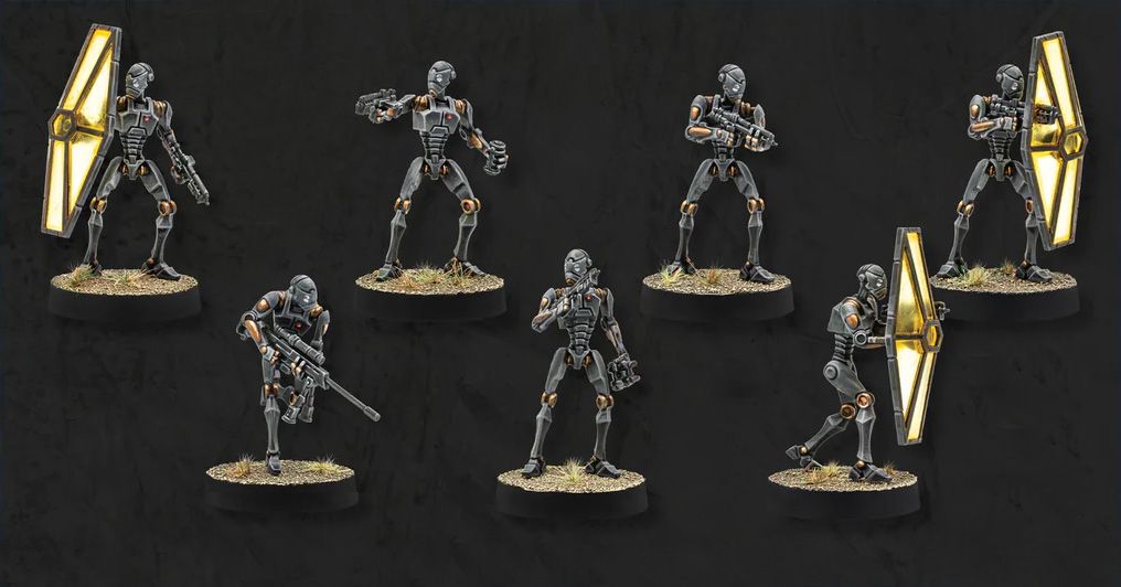 A collection of eight BX-Series Droid Commandos is displayed against a dark background, each standing on a circular base with tufts of grass. The droids are depicted in various poses, showcasing their sleek, metallic bodies with orange accents and distinct features, including weapons like blasters and a shield. This set highlights their versatility as both combatants and enforcers in the Star Wars: Legion game.