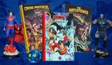 Justice League Unlimited RPG books, Crisis Protocol, The Watchtower, and a blue d20 die.
