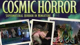 The image features the title "COSMIC HORROR" prominently at the top, with the subtitle "Supernatural Horror in Miniature" below it. Surrounding the title are several vintage-style photographs depicting scenes from the game: a group of characters, including men in suits and a woman in a blue dress, stand near a classic car, while monstrous entities loom in the background. The overall color scheme is dark and atmospheric, evoking a sense of mystery and horror typical of the 1930s Cthulhu Mythos.