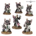 A collection of six miniatures representing the Emperor's Children, featuring a mix of elite warriors and Noise Marines. Each model is adorned in black armor with vibrant pink accents, showcasing intricate details such as ornate shoulder pads and weaponry. The miniatures are posed dynamically, with some holding large guns and others displaying unique features like skulls and decorative elements, all set on textured bases with grass and rocks.