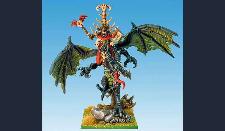 A detailed miniature depicts a liche king riding a zombie dragon. The liche king, adorned with skulls and a flowing red robe, holds a staff topped with a skull in one hand and a book in the other. The dragon features tattered wings and a menacing expression, with a long, serpentine body that includes skeletal elements. The base is grassy with rocky details, enhancing the undead theme of the scene. The background is a gradient of blue, emphasizing the figures in the foreground.
