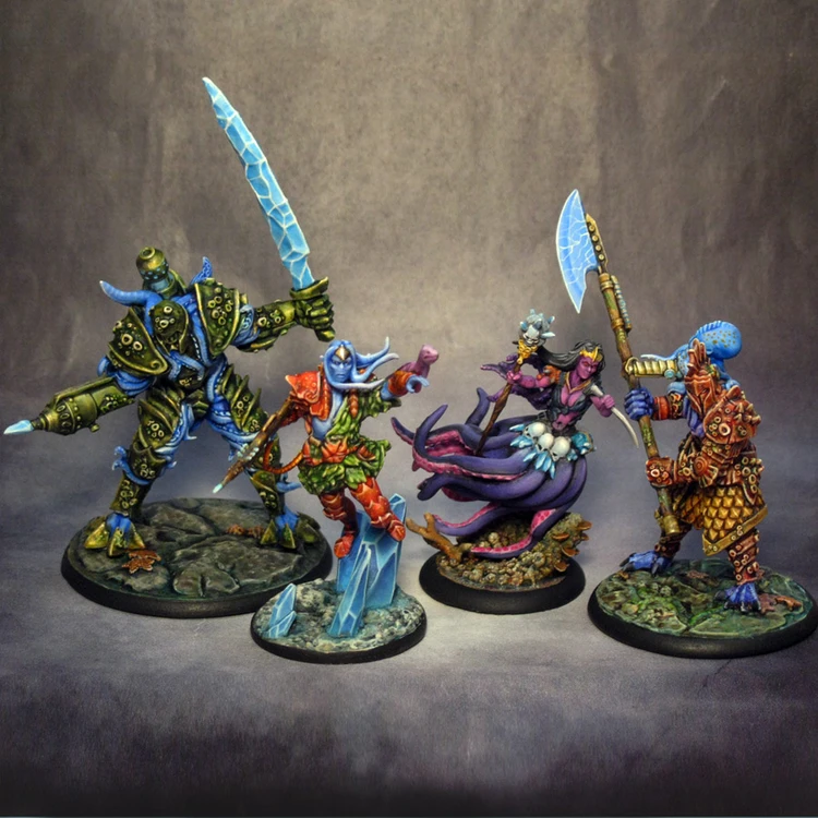Four intricately designed miniatures from the underwater tabletop skirmish game DeepWars are displayed against a neutral background. On the left, a large, armored figure with a green and blue color scheme wields a large ice sword. Next to it, a humanoid character in vibrant red and green attire gestures dramatically, showcasing blue skin and a confident expression. The third figure, a mermaid-like character with flowing purple hair and a shimmering tail, holds a staff adorned with a glowing orb. On the right, a warrior with a blue head and patterned armor brandishes a large axe, completing the diverse ensemble of characters. Each miniature is mounted on a textured base that reflects an underwater theme.