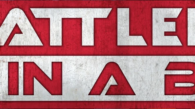 A bold graphic features the text "BATTLEFIELD IN A BOX" prominently displayed in large, stylized letters. The background is a textured red, contrasting with the white and silver elements of the text. The overall design conveys a strong, dynamic feel, suitable for a tabletop gaming context.