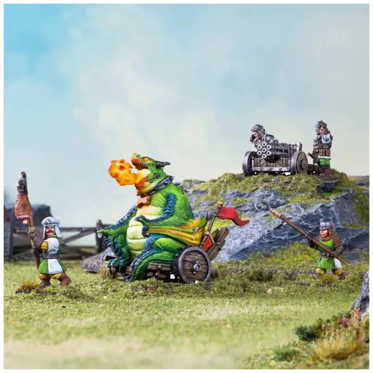 A vibrant scene features a large, green drakon belching fire while seated in a wheeled contraption, adorned with a red flag. Surrounding it are halfling figures: one holding a spear, another operating a multi-barreled cannon, and a third preparing to fire a weapon. The backdrop includes rocky terrain and grassy patches, creating a dynamic battlefield atmosphere.