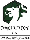 A logo for Chaosium Con UK features a stylized dragon's head in white, set against a dark green hexagonal background with a geometric design. Below the dragon, the text "CHAOSIUM CON" is prominently displayed in a bold, artistic font, with "UK" beneath it. The dates "21-24 May 2026" and the location "Cranfield" are included at the bottom in a simpler font.