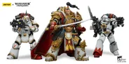 A detailed action figure of Jaghatai Khan stands on the right, adorned in ornate armor with intricate gold detailing, holding a sword. To the left, a Tactical Marine in Mk III power armor is posed with a firearm, featuring a skull motif and a red backpack. Both figures are set against a simple background, showcasing their impressive craftsmanship and articulation.