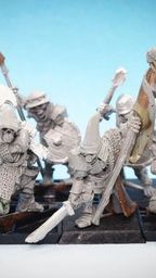 A collection of 28mm scale skeleton warriors from Diehard Miniatures, featuring several figures in various poses. The miniatures are equipped with weapons such as spears and swords, and are adorned with armor and helmets reminiscent of classic Oldhammer designs. The background is a soft blue gradient, highlighting the details of the skeletal figures, which are mounted on black bases.