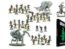 A collection of miniatures from Warlord Games' Konflikt ’47 is displayed, featuring various figures including soldiers, zombies, and mechanical creatures. Prominently featured is the book titled "Konflikt ’47: Festung Europa," which showcases a green silhouette on its cover. Among the miniatures, a notable figure in powered armor and a mechanical creature stand out, highlighting the game's unique blend of historical and fantastical elements.
