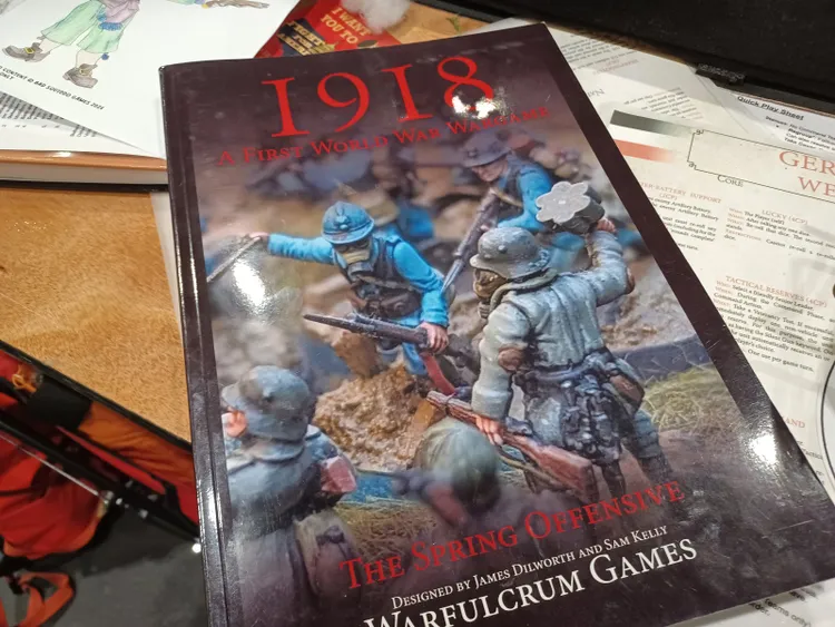 A close-up of a tabletop wargaming rulebook titled 