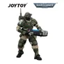 Green-armored Warhammer 40,000 action figure holding a large gun, with JOYTOY and Warhammer 40,000 logos.