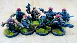 A group of eight intricately detailed miniatures representing space dwarves in a jungle setting, each standing on circular bases adorned with tufts of grass. The figures are dressed in military-style attire, featuring green clothing and red caps, with various weapons including guns and a curved blade. Their expressions are fierce and determined, showcasing a blend of ruggedness and character typical of old-school metal miniatures.