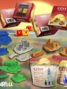 Catan game boxes, dice, and miniatures in Egypt, China, Greece, Germany styles.