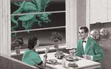 A 1950s couple dining at a table with a large insect outside the window.