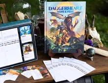 DAGGERHEART HOPE & FEAR book, cards, skull, globe, and scroll on a wooden table.