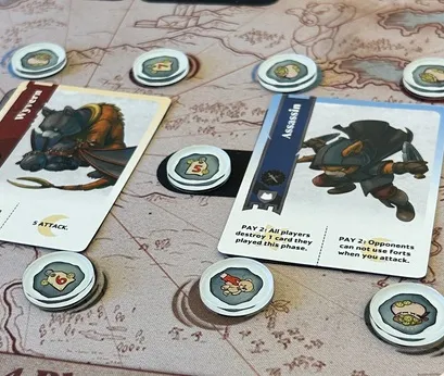 Board game with cards, tokens, and a map background.