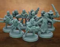 A collection of 28mm scale sci-fi miniatures features various characters, including a Space Commando, a Starchild, an Assault Goar, a Space Orc, and a Voidborn, all sculpted in a retro style reminiscent of the Rogue Trader era. The miniatures are displayed in a group, showcasing their unique designs and details, with some holding weapons and others in dynamic poses. The figures are unpainted and cast in a light gray material, set against a brown background.