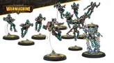 A dynamic group of miniatures from the Crucible Guard expansion for Warmachine, featuring several Rocketmen in mid-flight poses. Each figure is equipped with various weapons and wears a distinctive teal and brown color scheme, complete with goggles and mechanical details. The miniatures are mounted on clear bases, with tufts of grass visible on the black circular bases, enhancing their action-oriented display.
