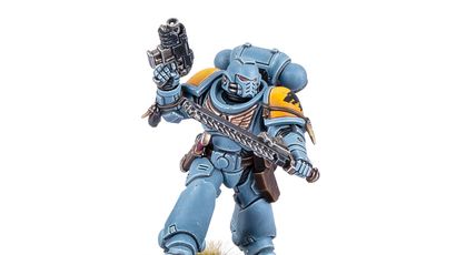 A Space Wolf Blood Claw miniature stands in a dynamic pose, wielding a chainsword in one hand and a pistol in the other. The miniature is painted in a striking blue color with yellow shoulder pads, showcasing intricate details and textures. It is mounted on a round base with a grassy terrain effect, emphasizing its role in the Warhammer 40,000 universe.