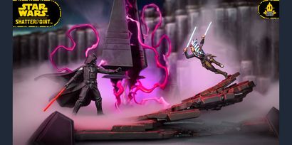 The image features a dynamic scene from the Star Wars: Shatterpoint game, showcasing miniatures of Ahsoka Tano and Darth Vader engaged in a duel. Ahsoka, wielding two lightsabers, is positioned in an action pose, while Darth Vader stands menacingly with his red lightsaber drawn. The backdrop includes a detailed scenic terrain piece resembling a Sith temple, with swirling purple energy and mist adding to the dramatic atmosphere of their confrontation.