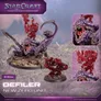 Three miniature figures on rocky terrain: a purple, clawed creature with a weapon, a red, spiked creature with a raised arm, and a close-up of their faces. Text reads: "STAR CRAFT TABLETOP MINIATURES GAME," "DEFILER," "NEW ZERG UNIT," and "©2020 Achon." Scale marker shows 60mm.